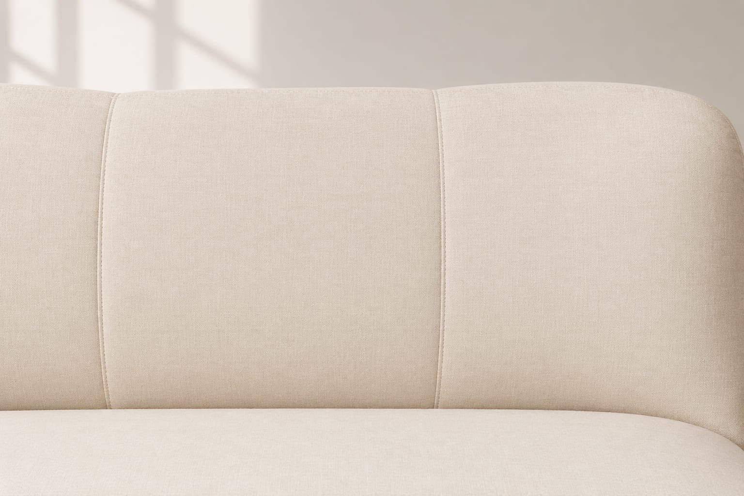 Close view of the upholstered seat and inner arm showing the junction between fabric and carved show wood